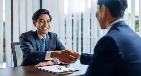 A job candidate shaking hands with an interviewer at the end of a successful  interview | Premium AI-generated image